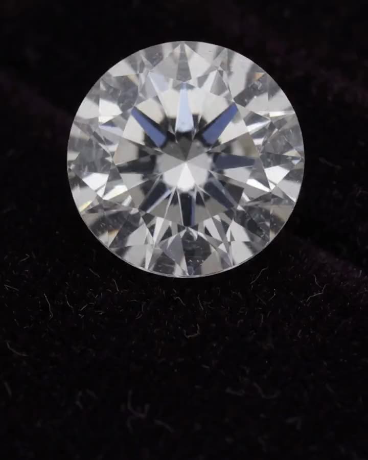 A round brilliant diamond on plum velvet.